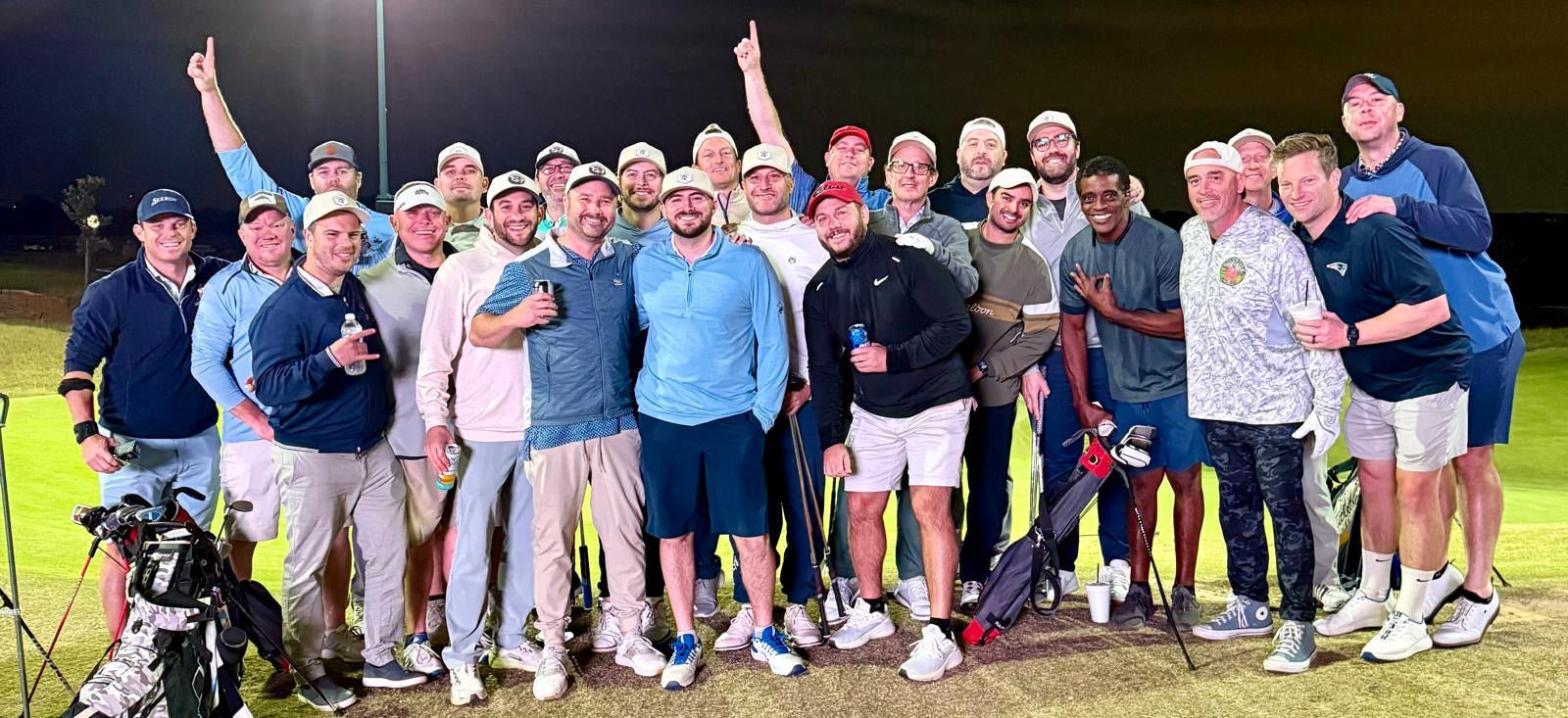 Group of golfers posing for a photo on a golf course
